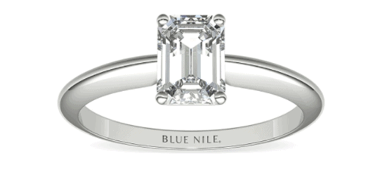 Solitaire setting with emerald cut center diamond
