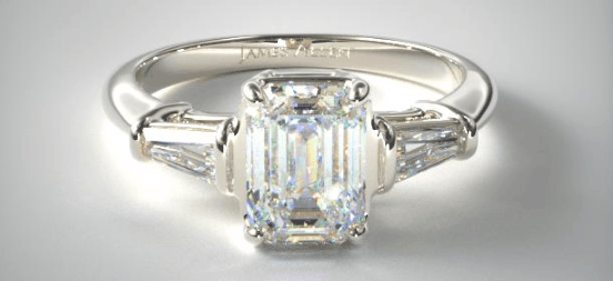Three stone setting with emerald cut center diamond