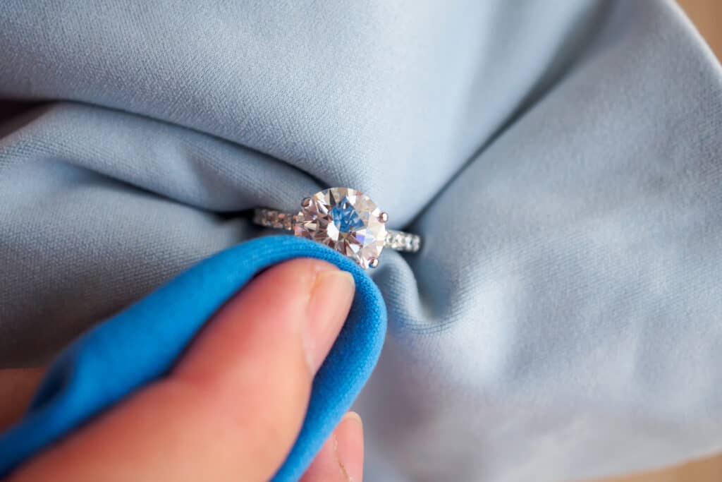 Cleaning a diamond engagement ring with lint-free cloth