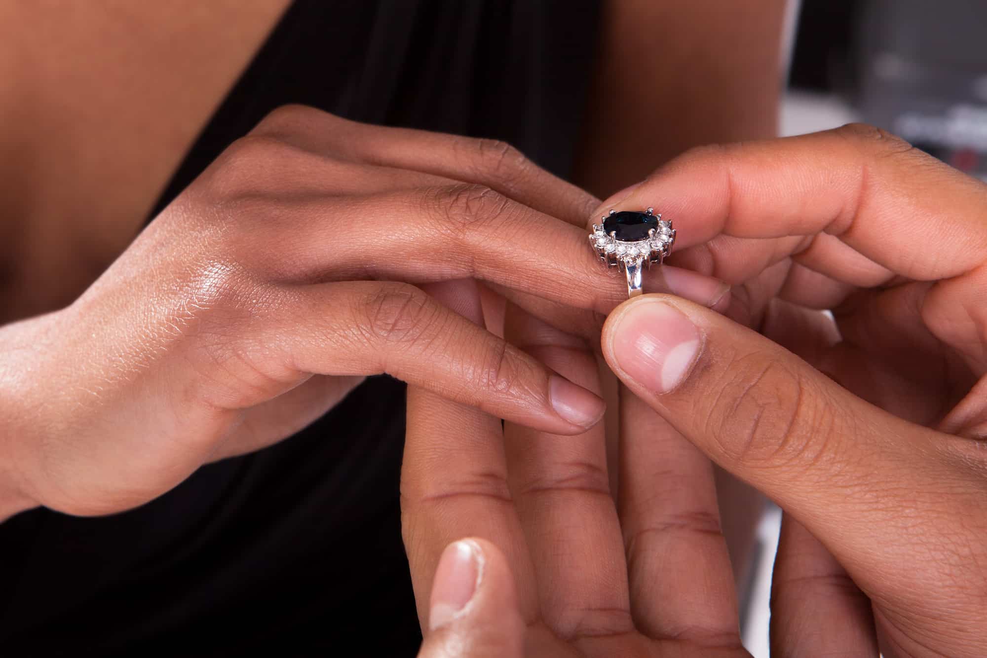 Bride And Groom With Engagement Gold Rings Put Their Hands On The Table,  And Next To Them Lies A Wedding Bouquet .Engagement Flowers .The Girl And  The Boy Put Their Hands On